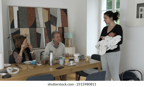 Family conversation during breakfast, multigenerational scene, newborn baby, elderly couple, cozy home, mother holding infant, casual morning, family bonding - Powered by Shutterstock