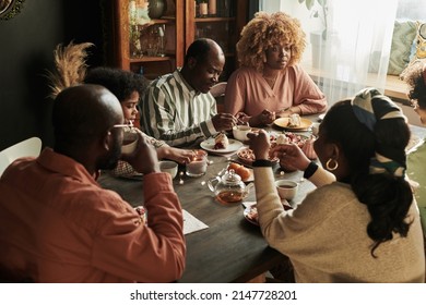 Family conversation over dessert at table - Powered by Shutterstock