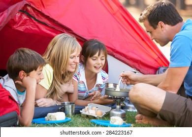 Family Cooking Breakfast On Camping Holiday