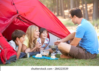 Family Cooking Breakfast On Camping Holiday