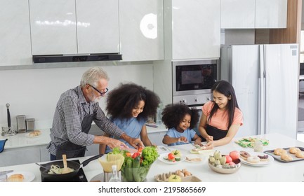 Family Cooking At Home. Happy Family Cooks Together In The Kitchen Home Recreation And Weekend Meal Prep.