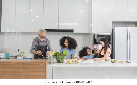 Family Cooking At Home. Happy Family Cooks Together In The Kitchen Home Recreation And Weekend Meal Prep.