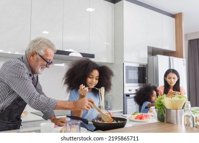 Family Cooking At Home. Happy Family Cooks Together In The Kitchen Home Recreation And Weekend Meal Prep.