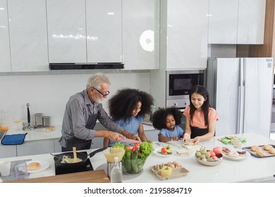 Family Cooking At Home. Happy Family Cooks Together In The Kitchen Home Recreation And Weekend Meal Prep.