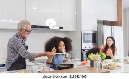 Family Cooking At Home. Happy Family Cooks Together In The Kitchen Home Recreation And Weekend Meal Prep.