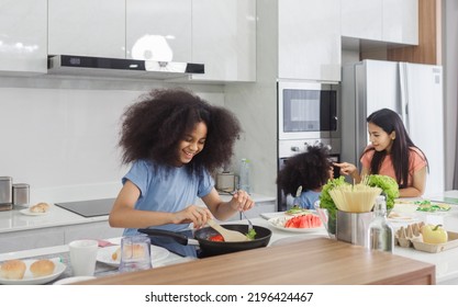 Family Cooking At Home. Happy Family Cooks Together In The Kitchen Home Recreation And Weekend Meal Prep.