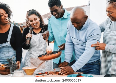 Family cooking at kitchen, Black people preparing healthy lunch outside rooftop house. Summer celebration and food concept - Powered by Shutterstock