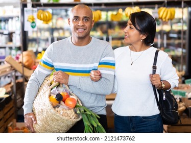 Family Couple With Bag Of Groceries With Grocery Store