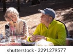 Family Couple Bonding Enjoying Together Outdoors Excursion in Mountain Grandma and Grandson Sitting in the Woods Picnic Area with Food and Drink