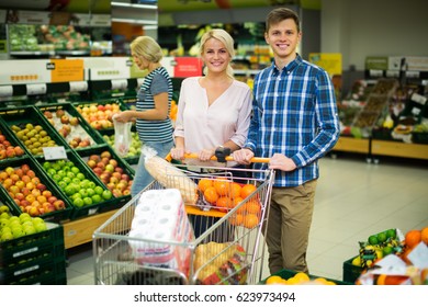 Family couple buying  fruits in local food shop