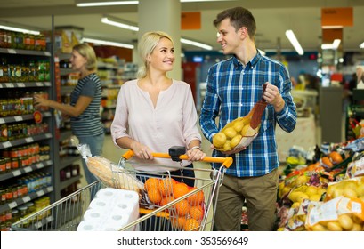 Family couple buying sweet fruits in local  shop