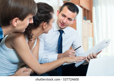 Family couple and insurance agent discussing possibility of mortgage
