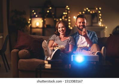 Family couple watching television at home on the sofa