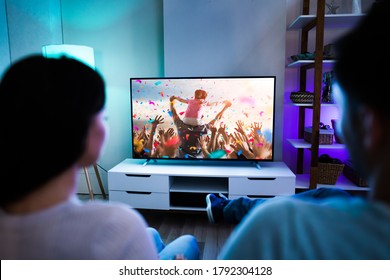 Family Couple Watching TV Or Movie On Couch