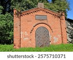 A family crypt inscribed "Erbbegraebniss der familie Laue auf Pinnau 1849." Znamensk, Kaliningrad region. German text