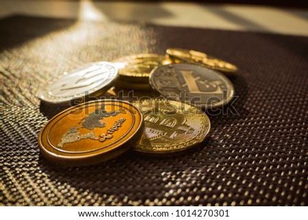 Family of cryptocurrency. Stack of shining golden and silver coins with sunlight on background. Crypto group. Ripple and litecoin dominance, Warm colours - photo of crypto coins.