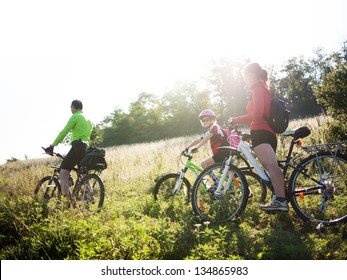 Family Cycling In Summer