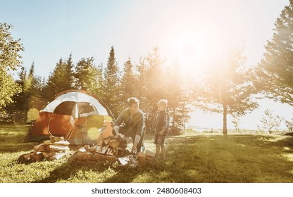 Family, dad and boy in woods for camping, adventure and holiday for summertime in countryside. Earth, sunshine and people in nature for travel, vacation and together with happy in forest for morning - Powered by Shutterstock