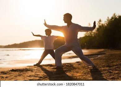 Family  dad and little son practice Tai Chi Chuan in the summer on the beach. solo outdoor activities. Social Distancing. family exercising  together. Simple living - Powered by Shutterstock