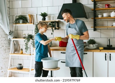 family dad young man and son teenage boy does household chores, doing laundry, men housework, household help in stylish kitchen in modern apartment, spend quality time together, father and son 