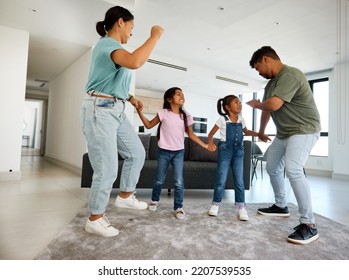 Family dancing, happy house and parents teaching children to dance, moving to music together and smile for love in home living room. Silly girl kids playing with fun mother and father in lounge