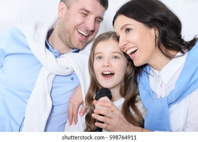 Family With Daughter Singing Karaoke