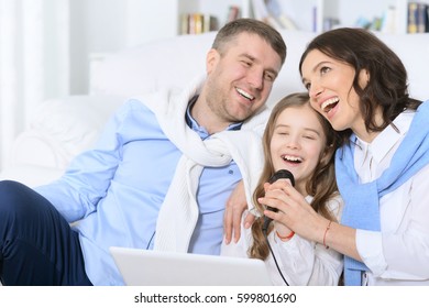 Family With Daughter Singing Karaoke