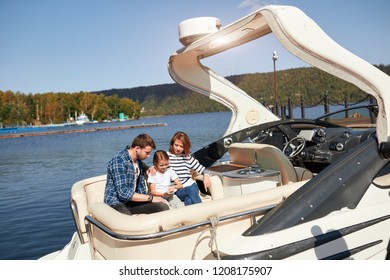 Family With Daughter Spending Time Together On Sailboat