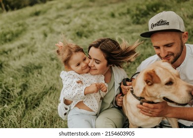 family with daughter walking with retriever dog in the park - Powered by Shutterstock