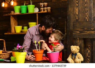 Family Day. Greenhouse. Happy Gardeners With Spring Flowers. Father And Son. Fathers Day. Flower Care Watering. Soil Fertilizers. Bearded Man And Little Boy Child Love Nature. New Flowers.