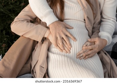 Family day. Stylish unrecognisable marriage pregnant couple waiting for baby. Man is hugging and touching woman belly outdoors. World IVF Day. Pregnancy, parenthood, motherhood, love, family concept