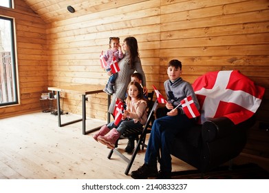 Family With Denmark Flags Inside Wooden House. Travel To Scandinavian Countries. Happiest Danish People's .