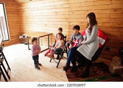 Family With Denmark Flags Inside Wooden House. Travel To Scandinavian Countries. Happiest Danish People's .