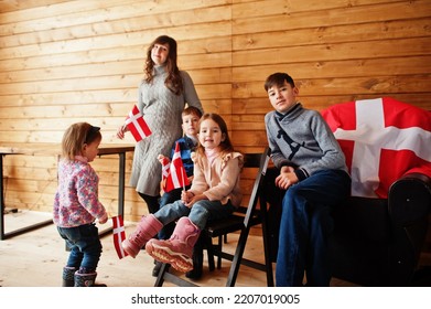 Family With Denmark Flags Inside Wooden House. Travel To Scandinavian Countries. Happiest Danish People's .