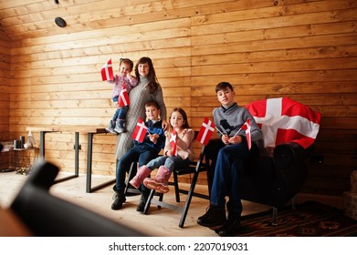 Family With Denmark Flags Inside Wooden House. Travel To Scandinavian Countries. Happiest Danish People's .