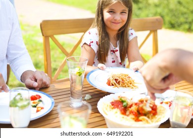 Family Dinner Variety Of Italian Dishes On Wooden Table In The Garden