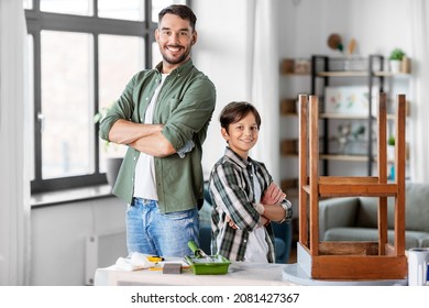 Family, Diy And Home Improvement Concept - Happy Smiling Father And Son With Ruler Restoring Old Table