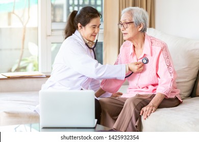 Family Doctor Or Nurse Checking Smiling Senior Patient Using Stethoscope During Home Visit,young Female Home Caregiver,health Visitor Examining Asian Elderly Woman,healthcare Medicine Concept