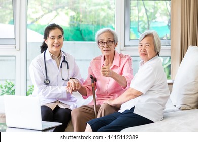 Family Doctor Or Nurse With Stethoscope And Support With Smiling Senior Patient During Home Visit,young Female Caregiver,health Visitor Holding Asian Elderly Woman Hand,healthcare Medicine Concept