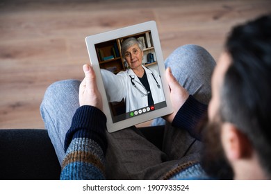 Family Doctor In Online Consultation With Patient At Home On Tablet Device In Video Call - Remote Medicine Concept - Millennials Call Her Health Opinion Specialist