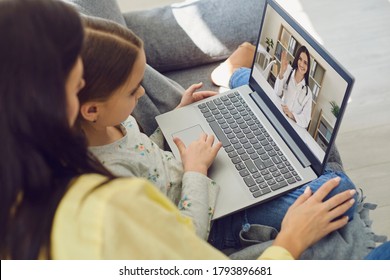 Family doctor online. Mom and little girl daughter are at home and use a video call to receive medical care online. Telemedicine concept. - Powered by Shutterstock