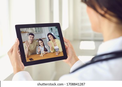 Family Doctor Online. Doctor Talking With Family With Illness Symptoms Prescription.