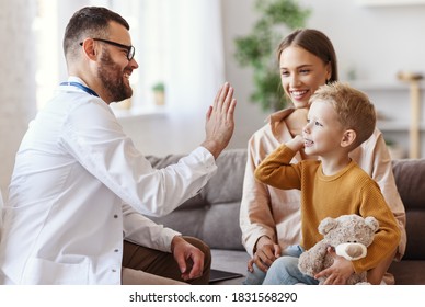 Family Doctor Pediatrician Conducts Examination Of Child Boy Who Came With His Mother,  And Giving High Five To Him  
