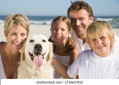 Family With Dog On Beach