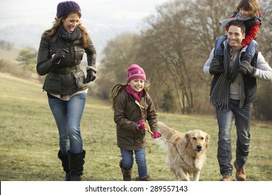 Family And Dog On Country Walk In Winter