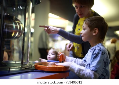 Family Doing A Physical Experiment In Laboratory