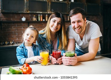 Family drink juice in the kitchen. Health care concept. - Powered by Shutterstock