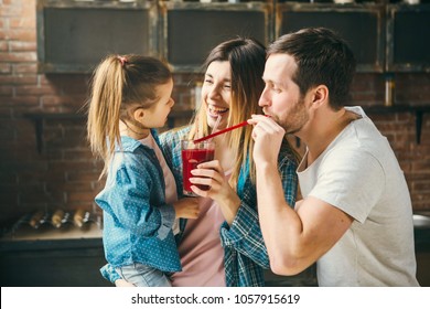 Family Drink Juice In The Kitchen. Health Care Concept.