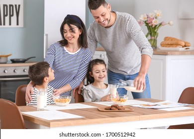 Family Drinking Milk During Breakfast At Home