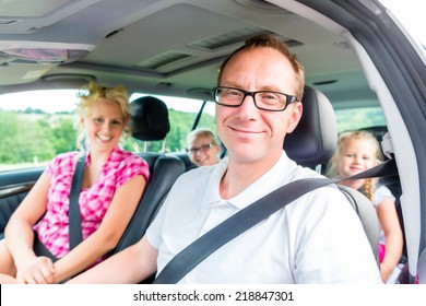 Family driving in car with seat belt fastened